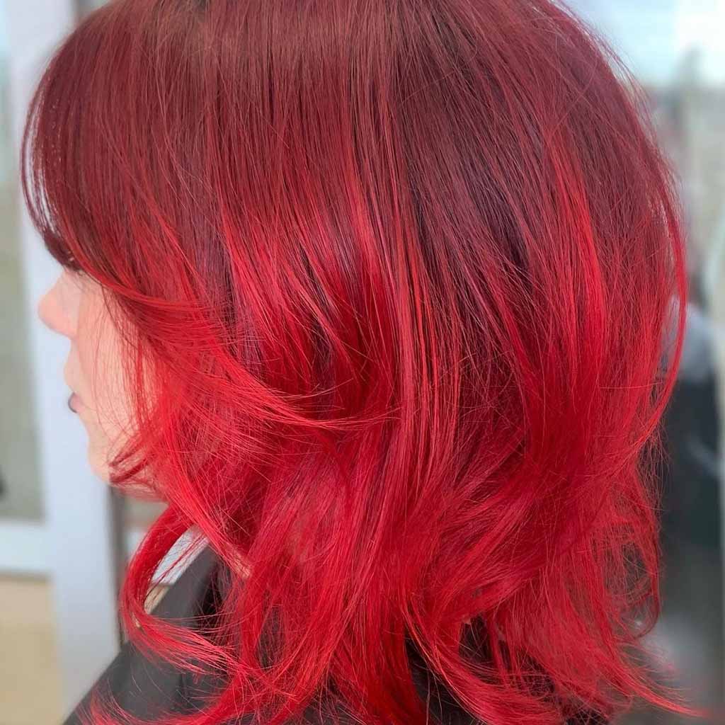 side shot of a girl with a red bob cut