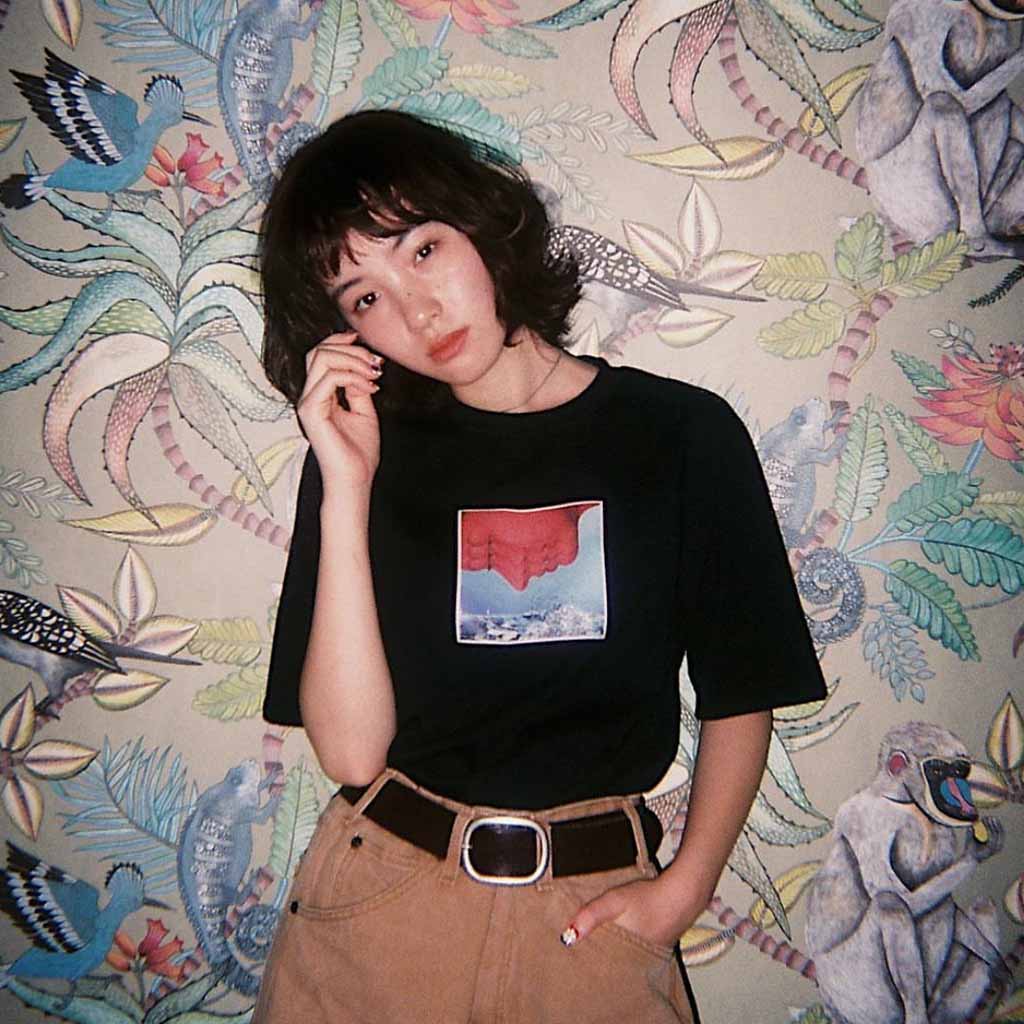 a photo of a girl with a bob cut, wearing a black tshirt