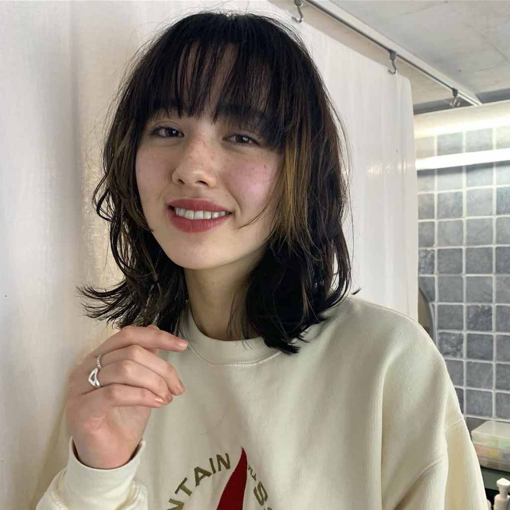 a girl with a bob wolf cut with choppy bangs