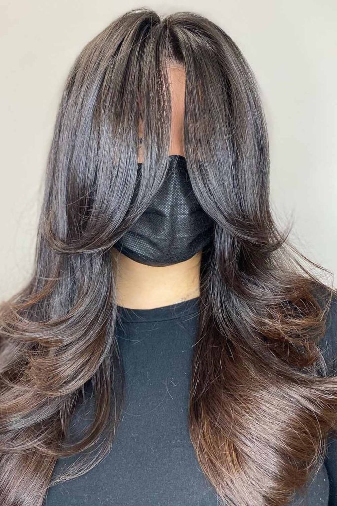 Feathered Layers with Face-Framing Curtain Bangs