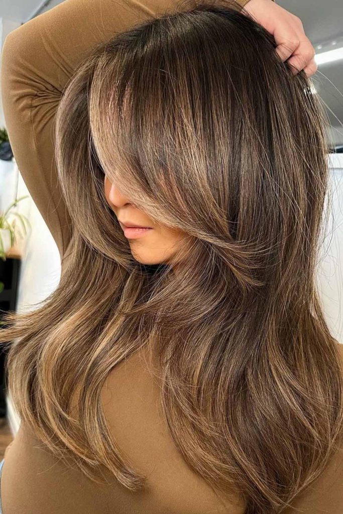 Layered Blonde Balayage With Dimensional Blends and Wispy Bangs